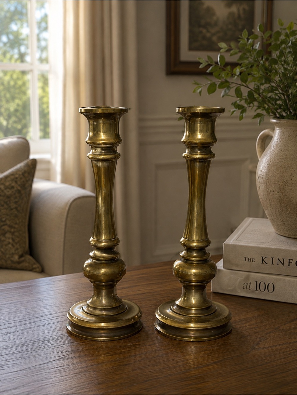 pair of vintage turned brass candlestick holders featuring round stepped bases l